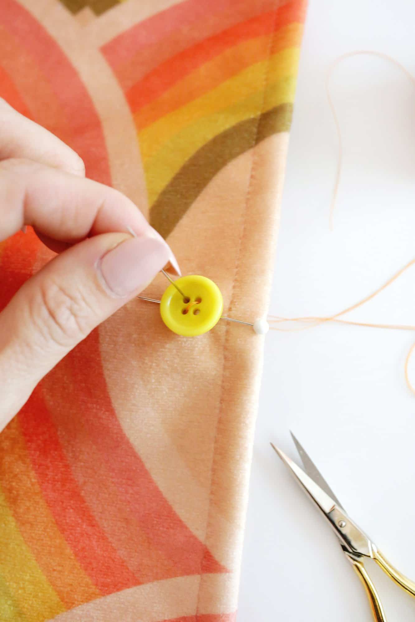 sewing a button onto fabric