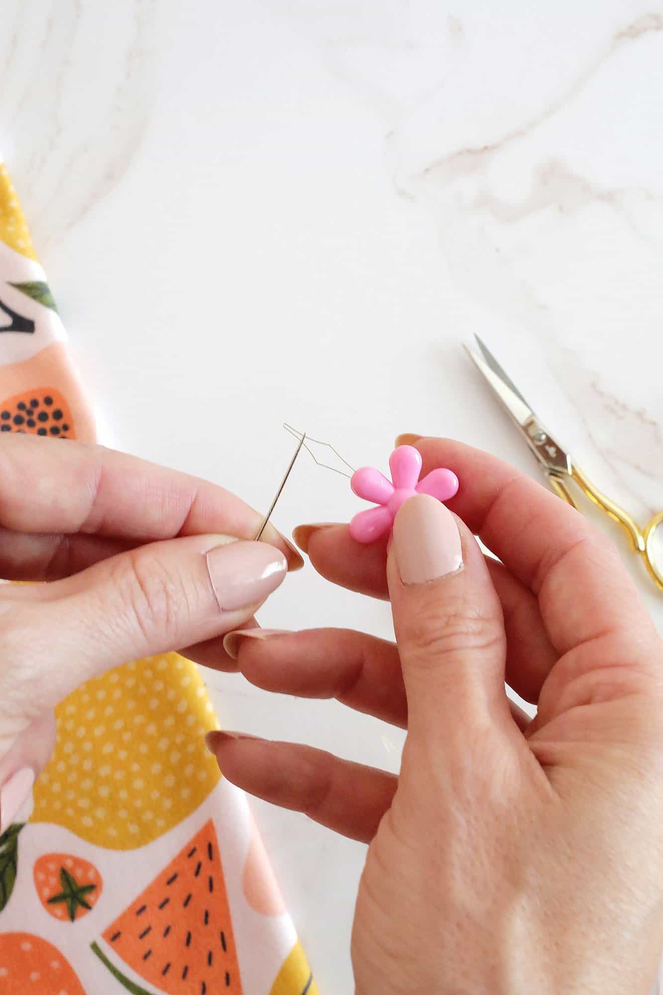 needle threader stuck through a needle eye